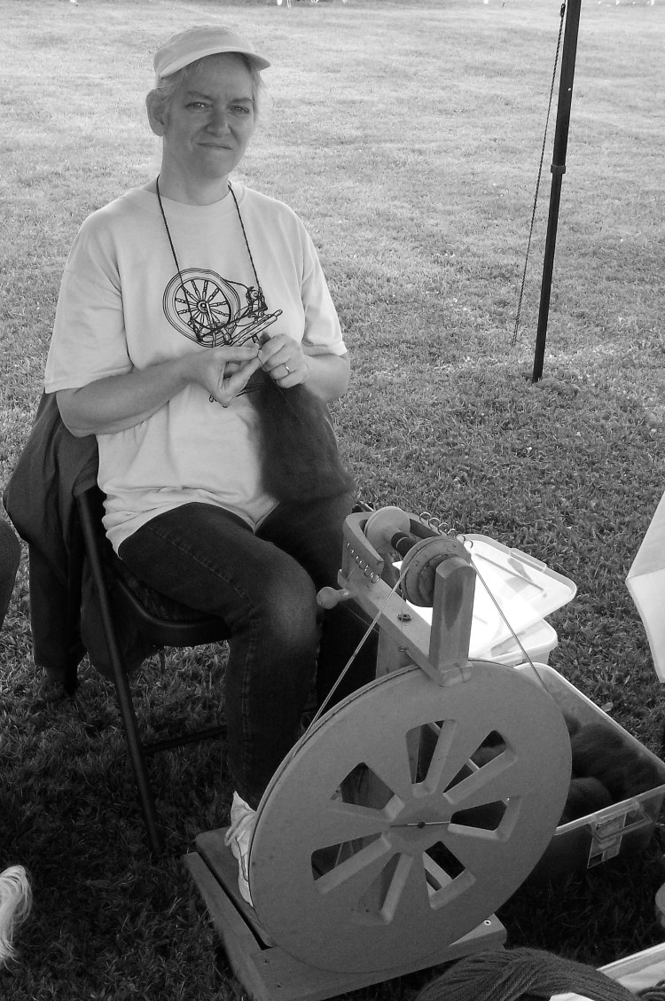 A lady spinning alpaca yarn using fiber from one of the local farms